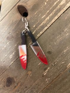 two pairs of knifes hanging from a wooden table