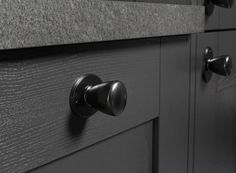 an image of a kitchen cabinet with knobs and handles