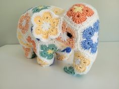 an elephant made out of crochet with flowers on it's trunk and tusks