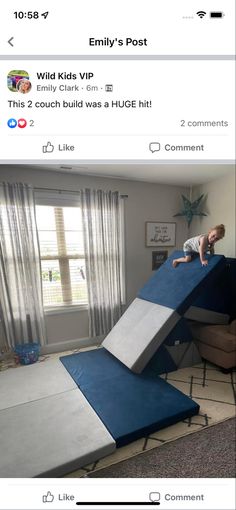 a kid is playing on a blue and white bed with a slide in the middle