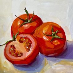 two tomatoes are shown on a white surface