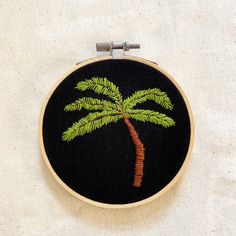 a small embroidered palm tree on a black background