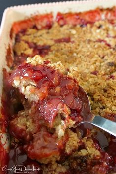 a close up of food in a pan with a spoon