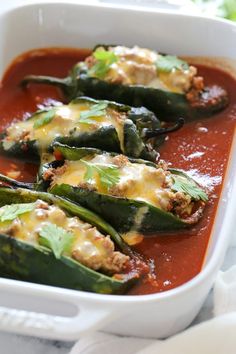 an image of stuffed green beans with sauce in a white casserole dish on instagram