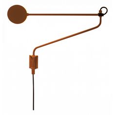 a wall mounted lamp with a circular light fixture on it's arm and an orange cord attached to the end