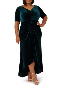 a woman wearing a green velvet dress