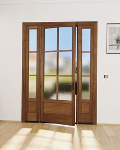 an empty room with wooden floors and two double doors that lead to the outside patio