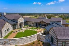 this is an aerial view of a home in the texas hill country with stone and brick exterior