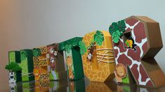 the letters are made out of cardboard and have animals on them, including giraffes