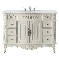 a white bathroom vanity with drawers and a sink