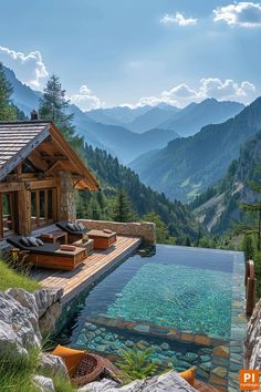 an outdoor swimming pool with chaise lounges and mountains in the background