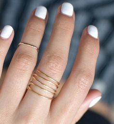 "This beautiful minimalist coil ring looks like stacked rings! Made from one continuous wire coiled into a lightweight ring. Handmade by wire wrapping shiny, beautiful gold-filled wire. DETAILS * Color: Gold * Available in a variety of sizes from 4 - 14 US/CA * Available Finishes: smooth or hammered * Because they're completely hand-formed, each ring will be unique. * Handmade from 14k gold-filled wire sourced in the USA. * Always Nickel Free WANT THIS RING IN 925 STERLING SILVER https://www.ets Coil Ring, Stacked Rings, Ring Wrap, Wrap Ring, Middle Part, Wrap Rings, Rose Gold Earrings, Stacking Ring, Rose Gold Color