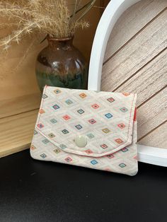 Keep this handy card case in your purse, wallet, or pocket to help you organize your credit, debit, and loyalty cards. When closed, it measures 4 1/2 inches wide by 3 inches tall. With 3 layered pockets inside there is plenty of room to hold lots of cards! I make these cases with tender loving care out of 2 coordinating colors of high quality quilters cotton. Each one is interfaced for added sturdiness and closes with a plastic snap in the center. *listing is for card case only, photo props not included Rectangular Coin Purse With Card Slots For Daily Use, Beige Bifold Coin Purse As Gift, Multicolor Rectangular Card Holder For Daily Use, Square Wallets With Card Slots For Everyday Use, Multicolor Card Holder With Card Slots, Everyday Rectangular Card Holder With Zipper, Beige Envelope Wallet With Card Slots, Beige Rectangular Card Holder For Travel, Beige Trifold Wallet With Card Slots For Daily Use