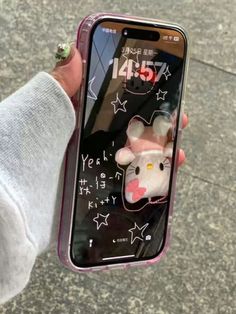 someone is holding their cell phone with an image of a mouse on the front and side