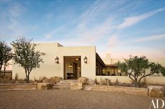 an adobe style home sits in the desert