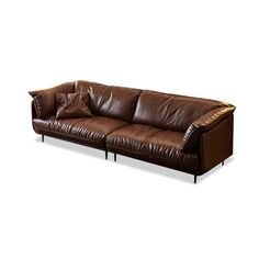 a brown leather couch sitting on top of a white floor