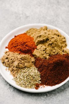 a white plate topped with different types of spices