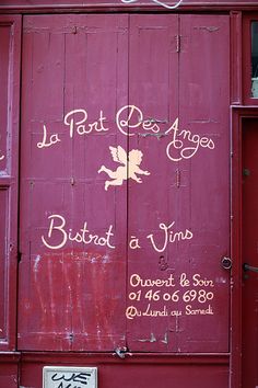 the side of a red building with writing on it that says la pat des anges bistro at vimos