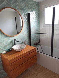 a bathroom with a sink, mirror and bathtub