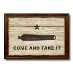 a wooden sign that says come and take it with a star on the top of it