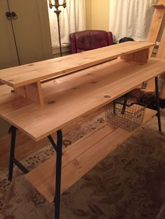 a wooden bench sitting on top of a hard wood floor