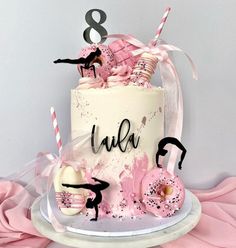 a birthday cake with pink frosting and decorations