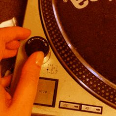 a person is pressing buttons on a record player