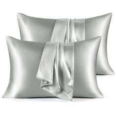 three pillows with satin ribbons on them