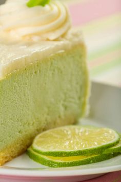 a close up of a slice of cake on a plate with a lemon wedge next to it