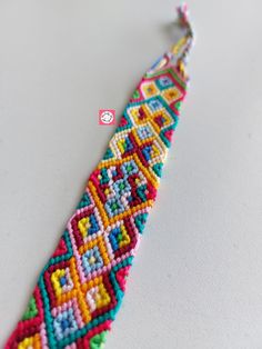 a colorful beaded bracelet on a white surface