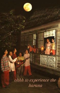 people are standing on the porch of a house at night with candles in their hands