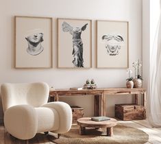 a living room with three pictures on the wall and a chair in front of it