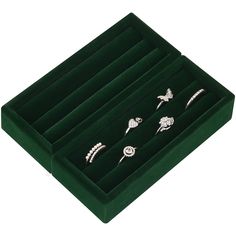 six pairs of rings in a green velvet box