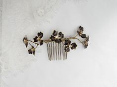 "Small Black and gold flower comb, style: #351 - Lightweight to wear comfortably - Enamel black and gold flowers adorned with diamante - Gilded, painted and sealed with a glossy black resin finish - Slightly pliable - Set on a 10 prong bronze metal comb Approximate Measurements including comb 4.5\" width 2\" height ------------------------------------------------- Please keep in mind before purchasing this product is \"MADE TO ORDER\" and has a production time of 1 - 2 weeks + shipping time to y Black And Gold Hair Accessories, Black And Gold Hair, Black And Gold Flowers, Gold Bridal Crowns, Gold Hair Piece, Floral Hair Combs, Bridal Headdress, Gold Hair Accessories, Flower Comb