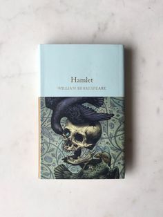 a book on hamlet written by william shakespeare with an image of a skull and a bird