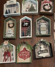 christmas cards are arranged on a table with holiday greetings in the boxes above them