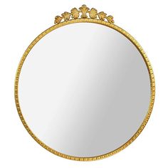 a round mirror with gold trimmings on it