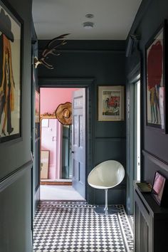 a hallway with black walls and checkered flooring