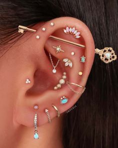 a woman's ear with different types of piercings