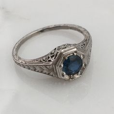 Details: Stunning Art Deco Period platinum and sapphire ring--would make a lovely wedding ring! The center stone is estimated .40 carats, and measures 4.9mm round. The filigree is beautiful on this ring, and is in lovely shape. This is a stunning ring--you will not be disappointed! Please ask all necessary questions prior to placing an order. Measurements: The size is 5 1/2 US and can be sized for a fee. Condition: The overall all condition of this ring is very good. Classic Sapphire Halo Ring, Classic Sapphire Ring In 14k White Gold, Formal Sapphire Diamond Ring In Platinum, Timeless Sapphire Promise Ring With Round Band, Timeless Sapphire Promise Ring, Formal Sapphire Diamond Cut Ring, Classic Sapphire Birthstone Ring, Formal Sapphire-colored Diamond Ring, Classic Formal Diamond Ring With Lab-created Sapphire