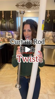 a woman is holding a pole in her hands with the words curtain rod hack twist on it