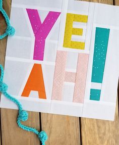 a piece of paper with the words yeh yah on it and some yarn