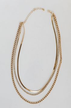 You'll be getting adoring looks left and right when you wear the Nova Gold Rhinestone Layered Necklace! This trendy necklace features three layers of gold chains with rhinestones. Style the Nova Necklace with any outfit to instantly add a chic touch to your look! Gold Plated Layered Rhinestones Snake Chain Lobster Clasp with Extender Layer 1 | Length 9" Layer 2 | Length 8" Layer 3 | Length 7.5" Extender | Length 3" Chic Gold Necklaces With Rhinestones, Gold Rhinestone Chain Necklace In Trendy Style, Trendy Gold Rhinestone Chain Necklace, Gold Multi-strand Necklace For Layering, Elegant Multi-strand Layered Necklace With Gold Chain, Gold Chain Multi-strand Layered Necklace, Formal Gold Multi-strand Layered Necklace, Adjustable Gold Multi-strand Layered Necklace, Cute Necklaces