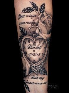 a black and white tattoo on the arm of a person with a heart shaped pocket watch