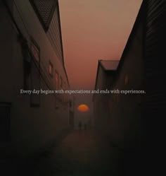 the sun is setting behind two buildings on a foggy day with an inspirational quote