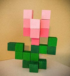 a pink and green piece of paper sitting on top of a table