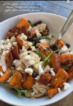 a white bowl filled with chicken and vegetables