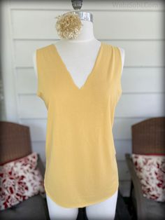 a mannequin with a yellow top on it