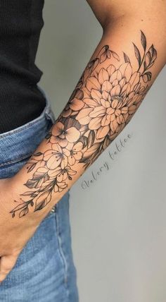 a woman with a flower tattoo on her arm