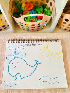 there is a notebook with an image of a whale on it and other toys in the background